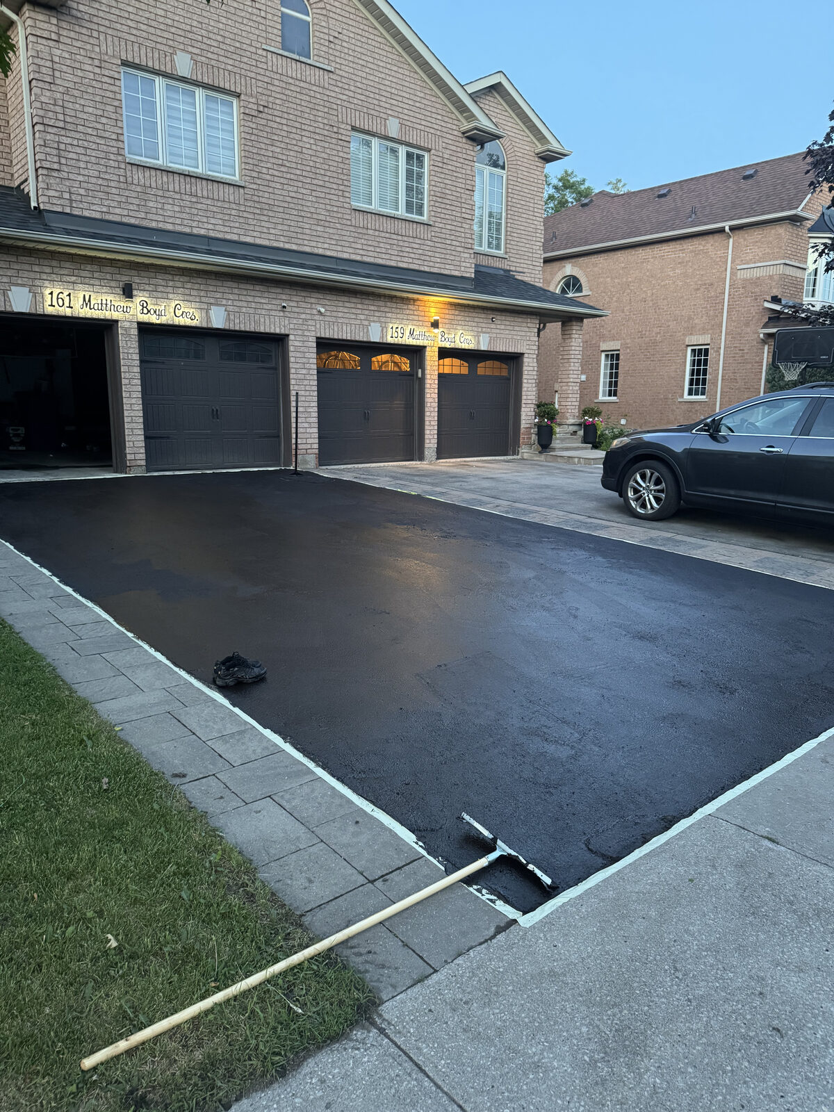 Freshly sealed, deep-black driveway after York Seal service